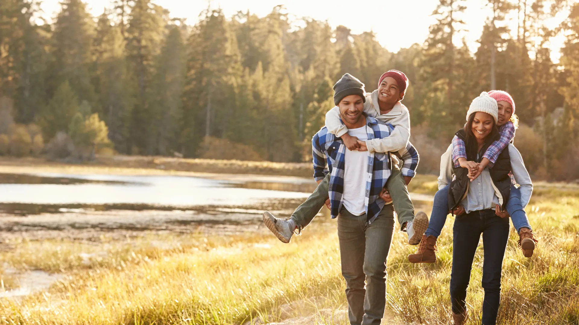 Families silhouetted at sunset in an open meadow