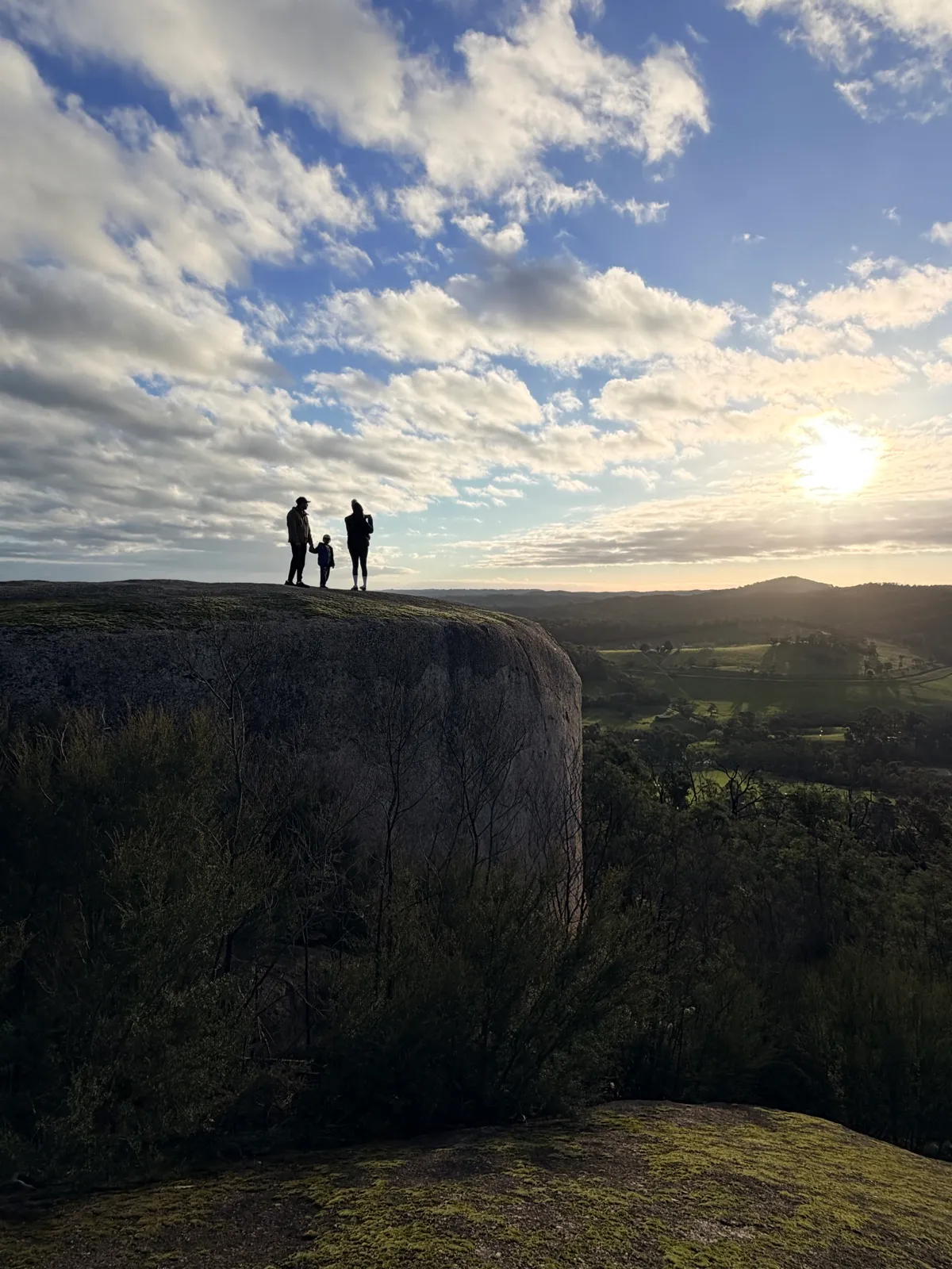A family hiking a bushland circuit loop with their young explorer