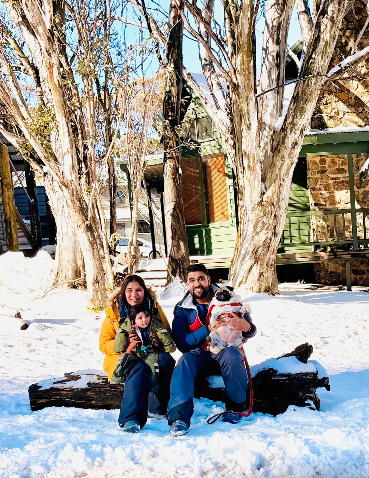A family playing in the snow at Dinner Plain in winter
