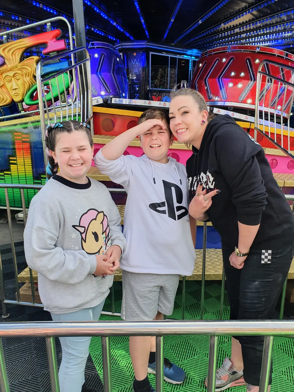 A family lit up with their kids at the night carnival